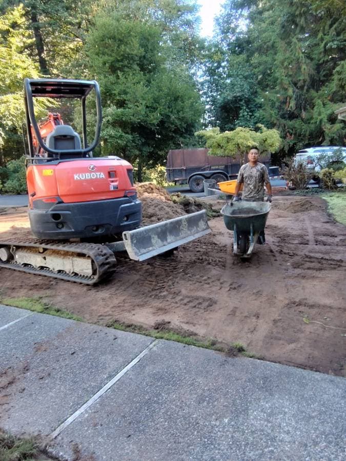 picture of a driveway being graded and prepped to have concrete put in
